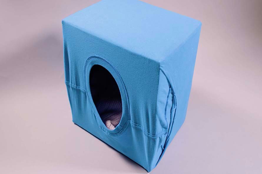 End result of cat hideaway made from a t-shirt and cardboard box