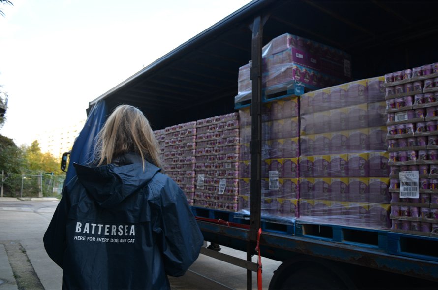 A person taking a delivery of pet food