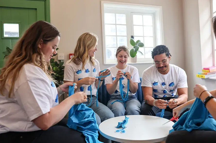 A group of people crafting dog toys