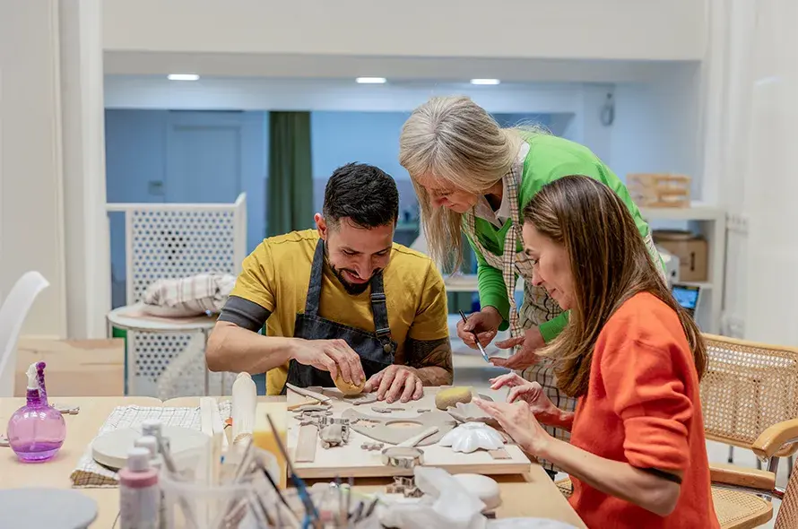 A group of adults crafting with clay