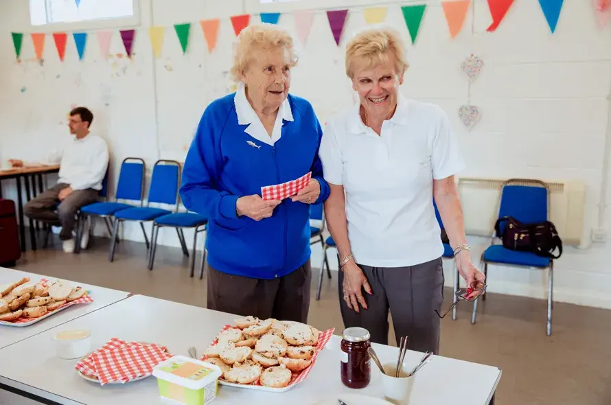 Elderly people at a bake sale